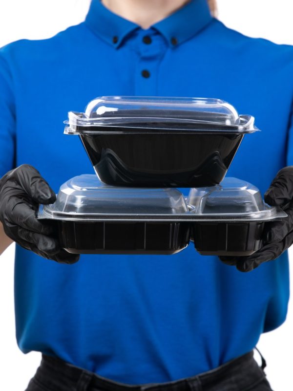 front-view-young-female-courier-blue-uniform-black-gloves-black-mask-holding-food-delivery-bowls (Büyük)